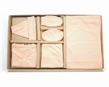 Set of beige fabric items in a cardboard box on a white background