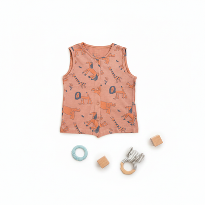 Baby vest with animal pattern and baby toys on a white background